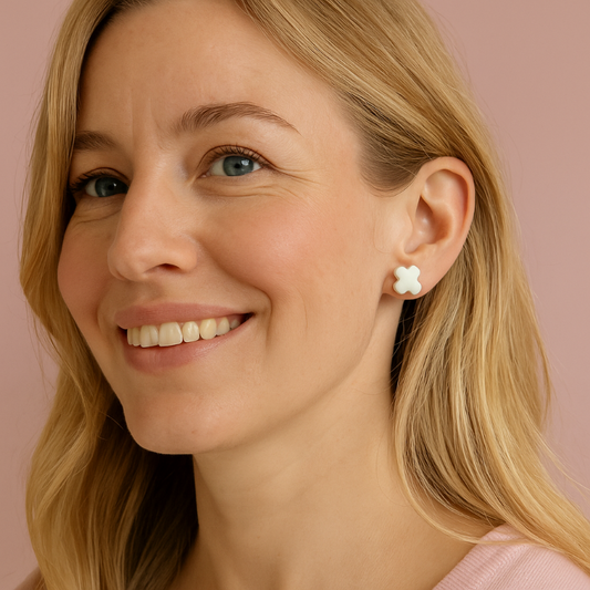 Woman wearing white cross earrings
