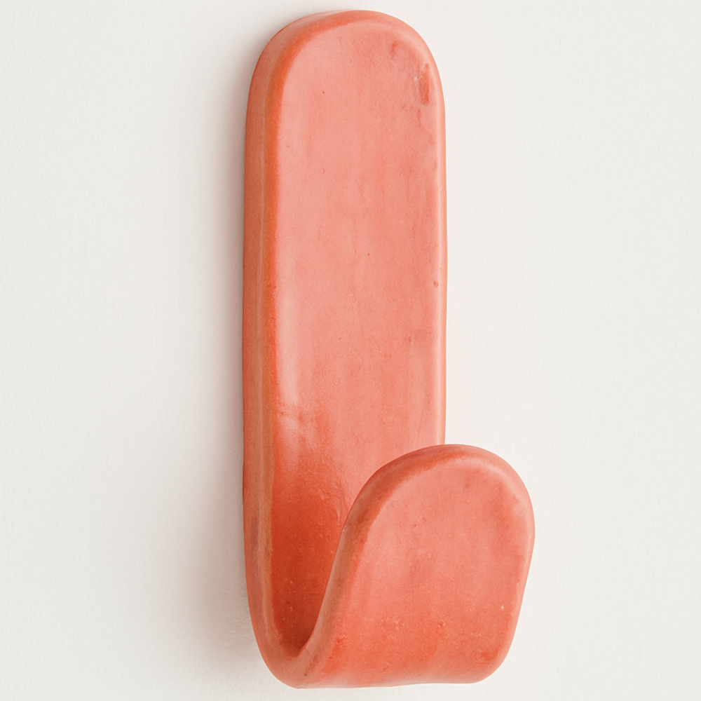 Handmade coral ceramic wall hook with glossy glaze, made in Australia by Fields and Seas.