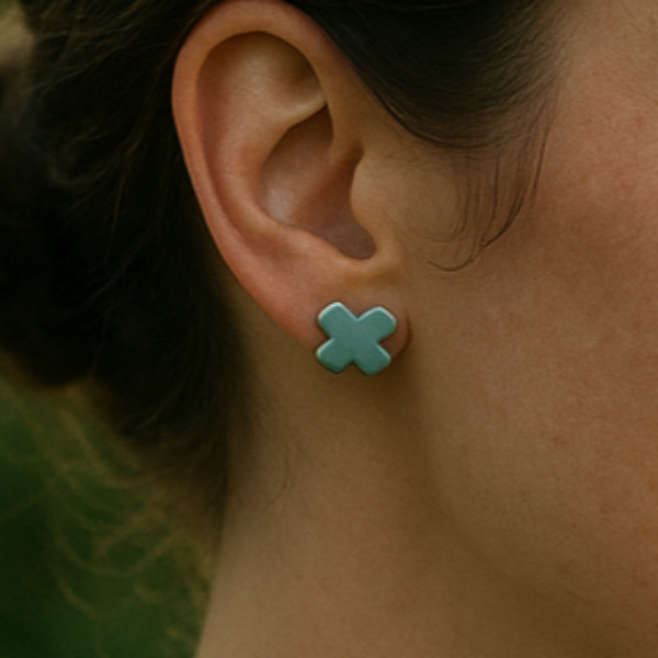 Handcrafted Laguna porcelain cross earrings displayed on a model