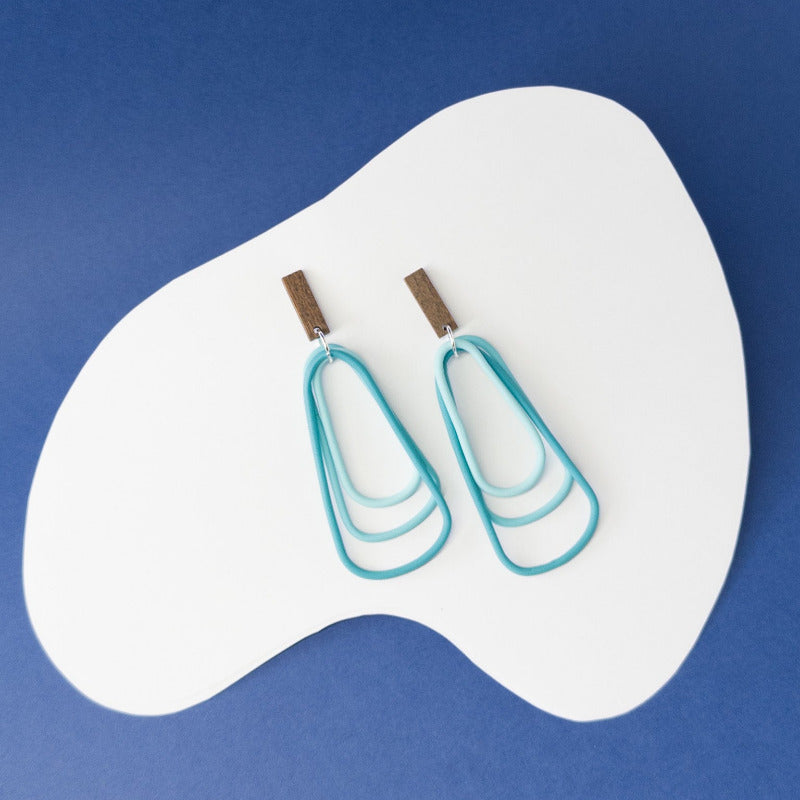 Vibrant teal dangles that echo the calm strength and beauty of ocean waters