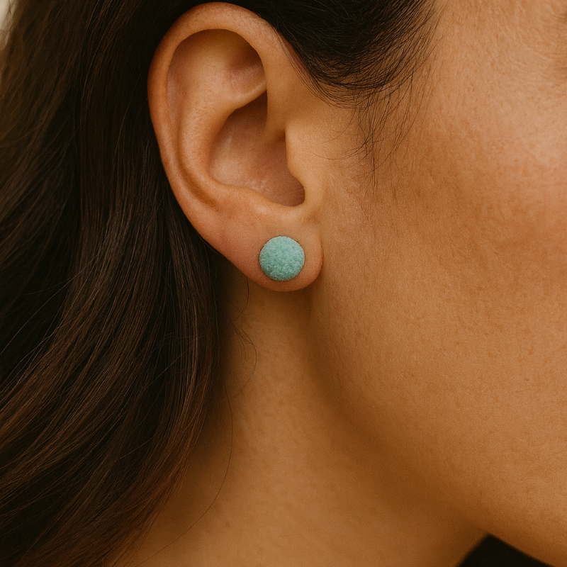 Close-up of handcrafted sea urchin studs in laguna porcelain with textured detail