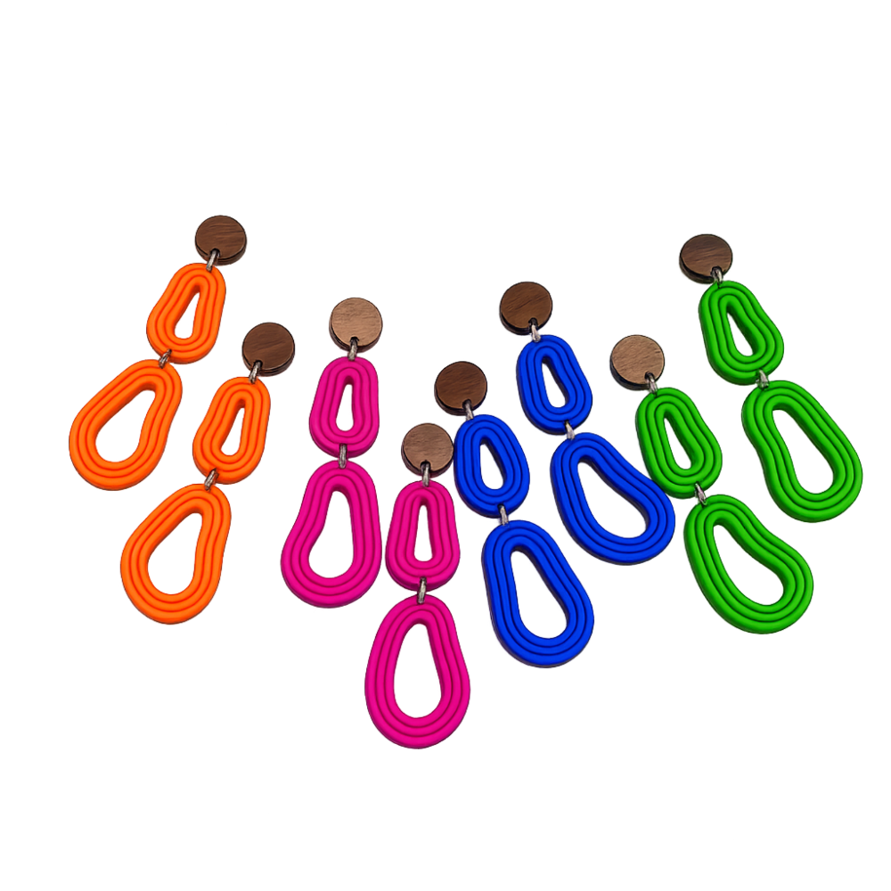 Bright organic polymer clay dangle earrings with timber studs in multiple bold colours on a white background