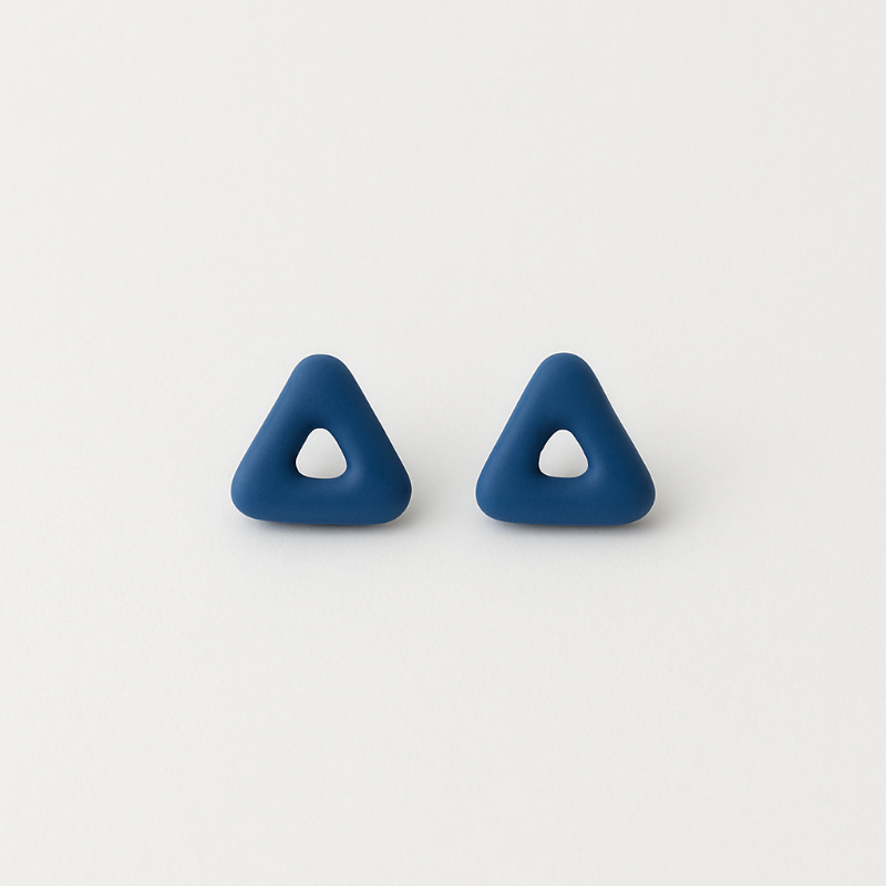 Close-up of triangular cobalt porcelain studs showing detail and texture