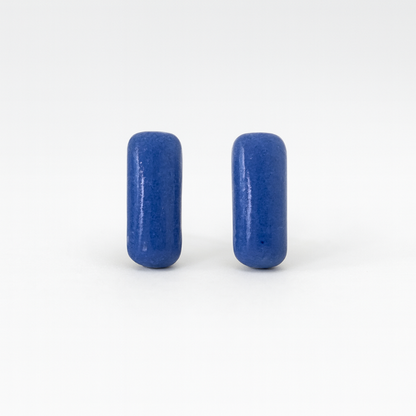 Close-up of cobalt blue porcelain bar earrings with glossy finish