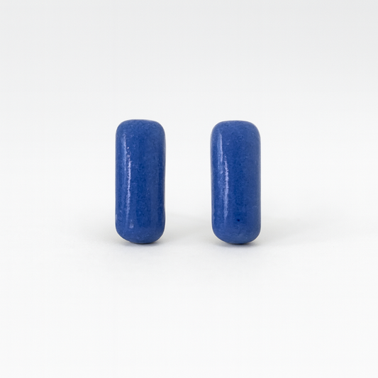 Close-up of cobalt blue porcelain bar earrings with glossy finish