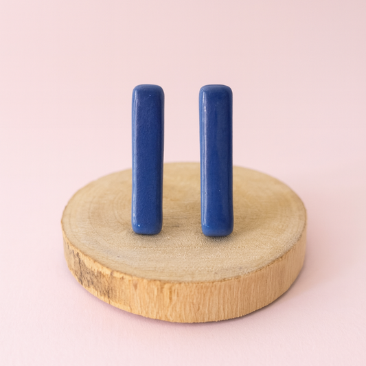Elegant blue ceramic bar studs styled with casual outfit