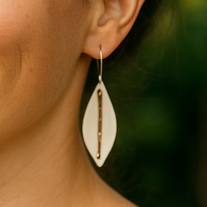 Porcelain earrings named Silverleaves featuring a white ceramic leaf form with hammered copper and sterling silver accents, hanging gracefully at approximately 6 cm in length. Inspired by the coastal beauty of Silverleaves, Phillip Island.