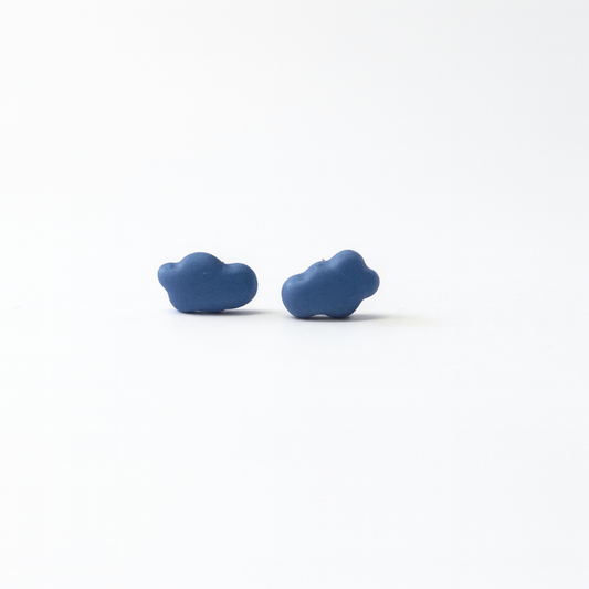 Pair of blue cloud-shaped earrings on a white background