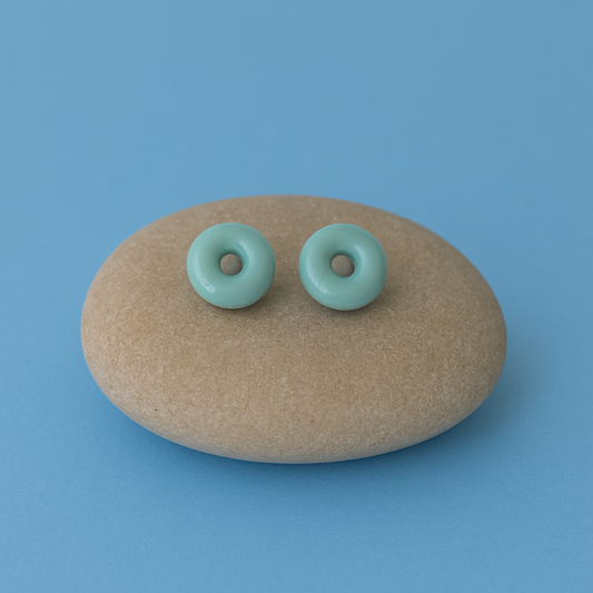 Lagoon turquoise blue porcelain circle stud earrings on river pebble