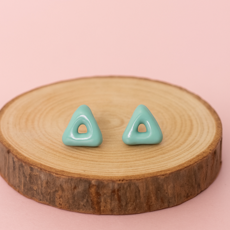 Handmade porcelain triangle arrow earrings on wooden prop