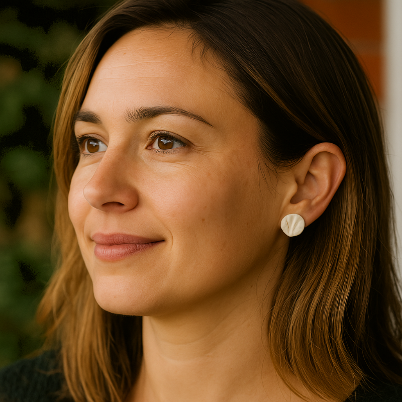 A pair of white porcelain coral-textured stud earrings displayed on model