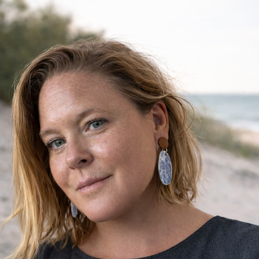 Woman wearing porcelain dangles with coral texture. Nature's Fingerprints of the sea.