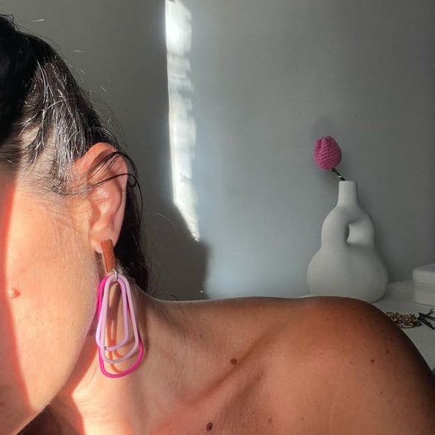 Pink ocean flow dangle earrings on model