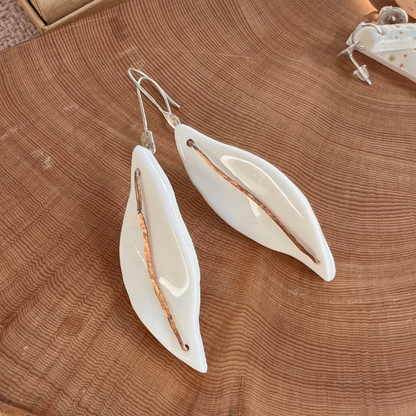 Porcelain earrings named Silverleaves featuring a white ceramic leaf form with hammered copper and sterling silver accents, hanging gracefully at approximately 6 cm in length. Inspired by the coastal beauty of Silverleaves, Phillip Island.