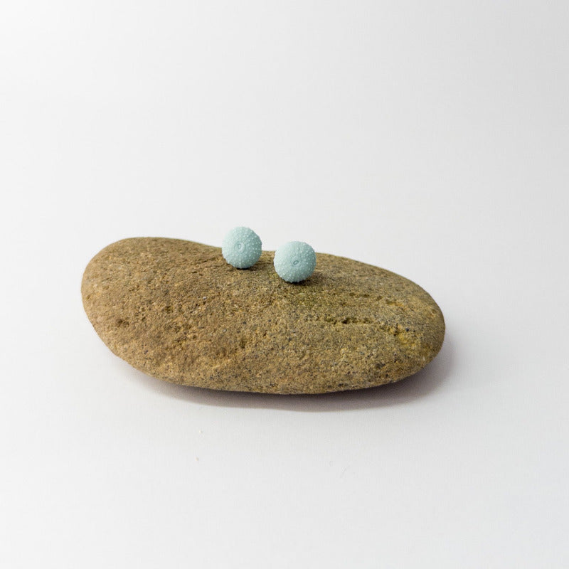 Minimalist ocean jewellery – porcelain urchin stud earrings on display prop