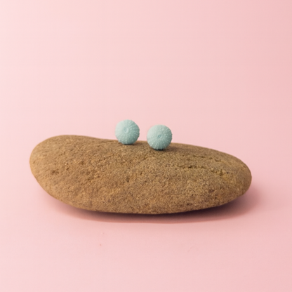 Minimalist ocean jewellery – porcelain urchin stud earrings on display prop