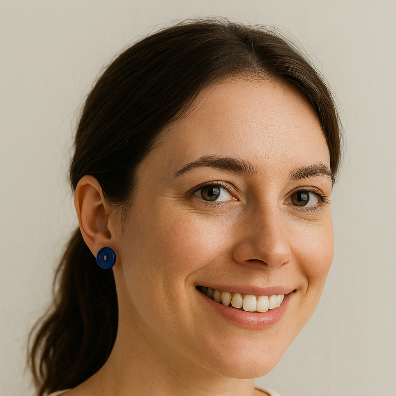 Model wearing cobalt blue porcelain circle studs, smiling