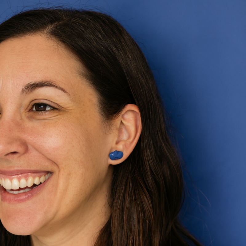 Lifestyle shot of woman wearing cobalt blue porcelain cloud studs in natural light