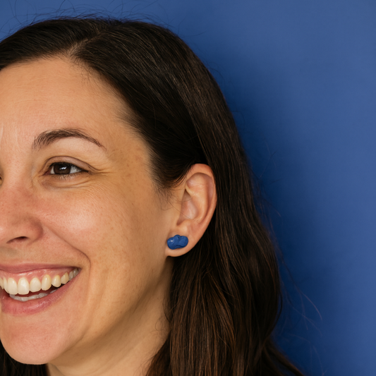 Lifestyle shot of woman wearing cobalt blue porcelain cloud studs in natural light