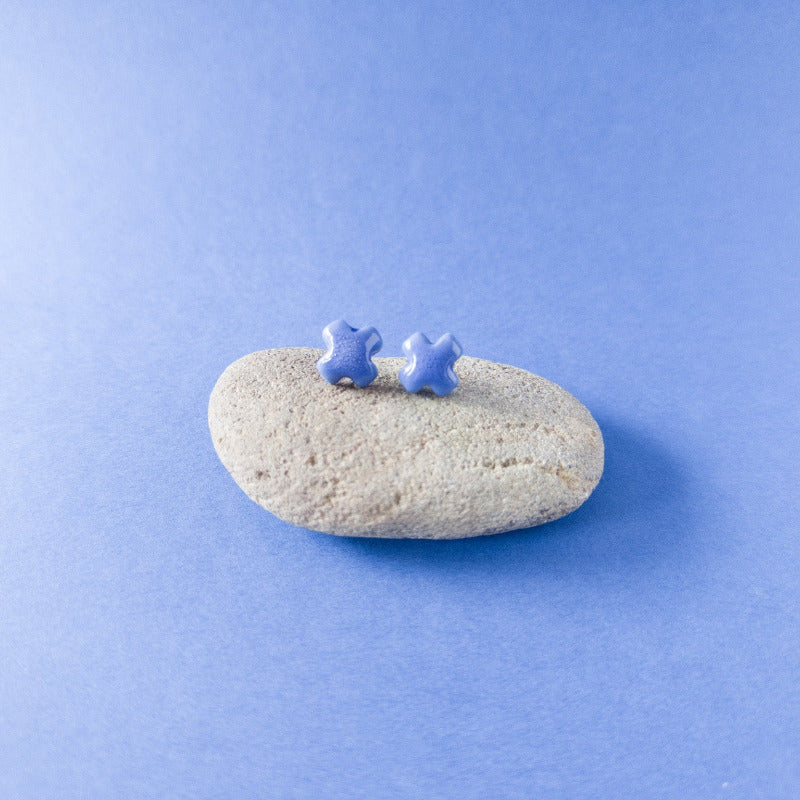 "Handmade blue porcelain cross studs — light, durable, and glossy"