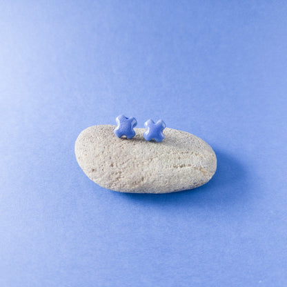 "Handmade blue porcelain cross studs — light, durable, and glossy"