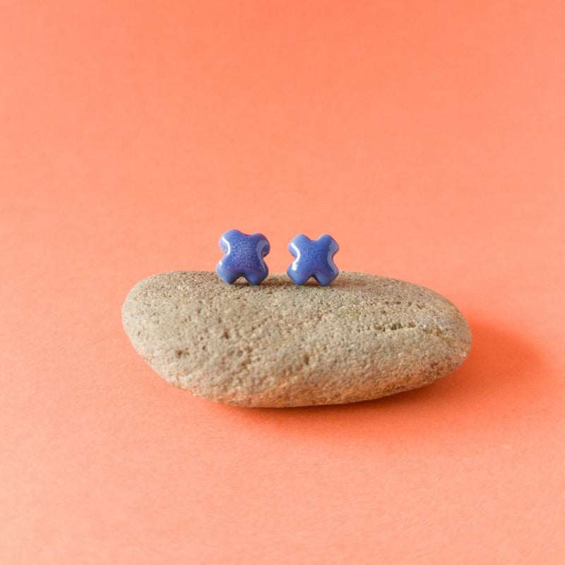Handmade blue porcelain cross studs — light, durable, and glossy