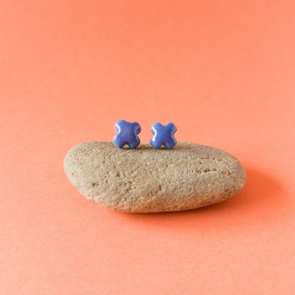 Handmade blue porcelain cross studs — light, durable, and glossy
