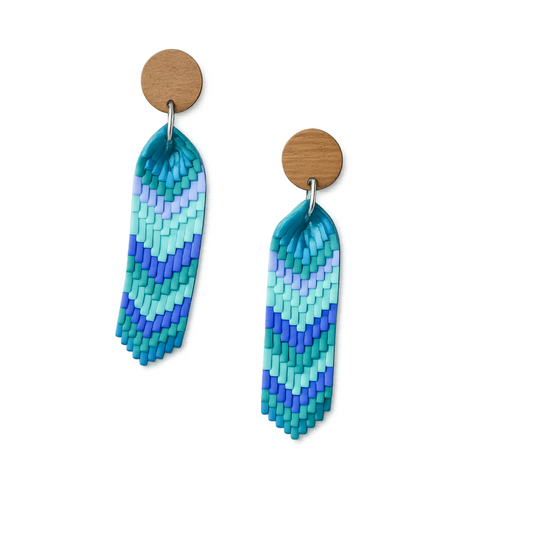 Handcrafted sea glass chevron polymer clay earrings in teal, aqua and blue gradient with wooden stud tops.
